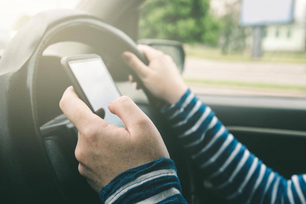 female driver distracted by cell phone