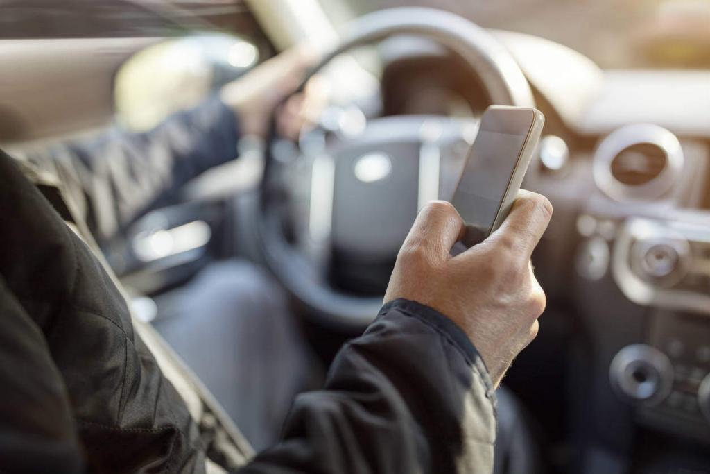 man using cell phone while driving